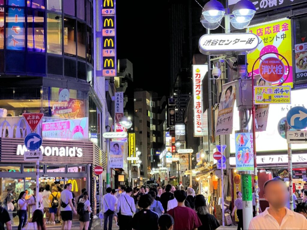 View of people and the shops at Shibuya during nighttime