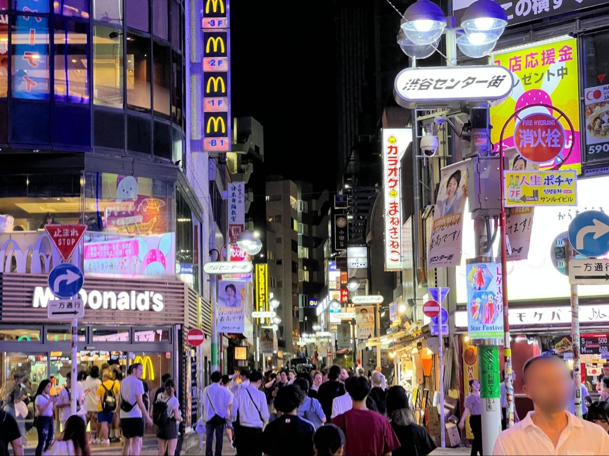 View of people and the shops at Shibuya during nighttime