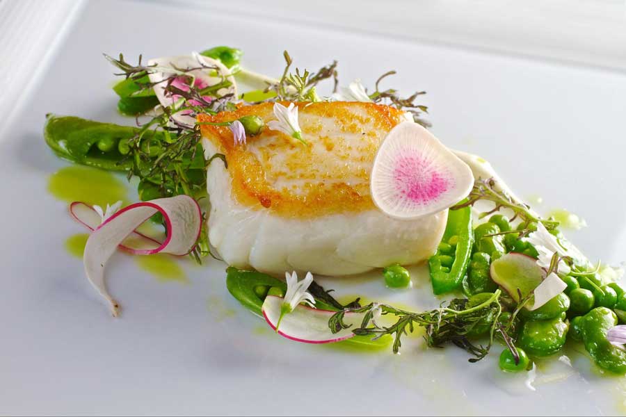 A colorful dish on a plate from Nine-Ten Restaurant & Bar