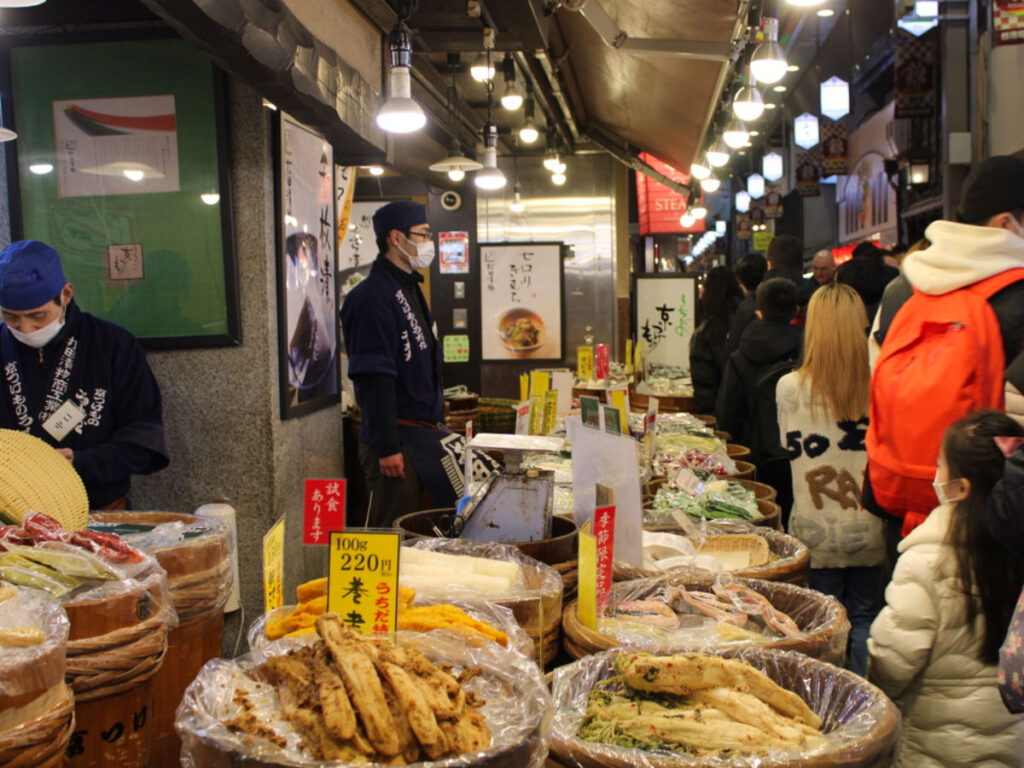 Crowd of people looking at local goods at Nishiki Market in the Nakagyo