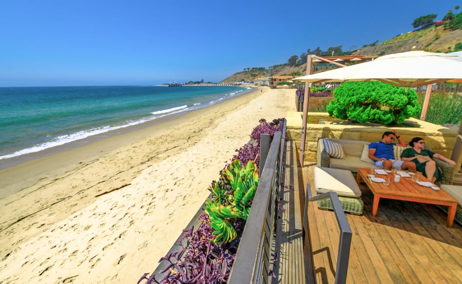A couple chilling outside the luxurious restaurant near the sea of Nobu Malibu