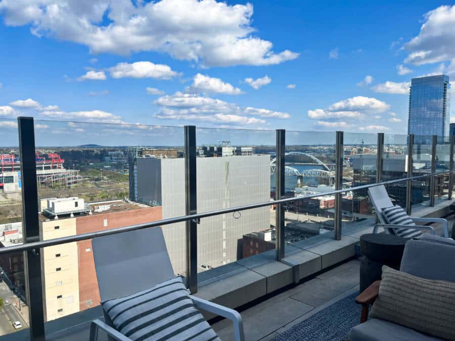 Overlooking view of the tall buildings from the rooftop seating area in Noelle