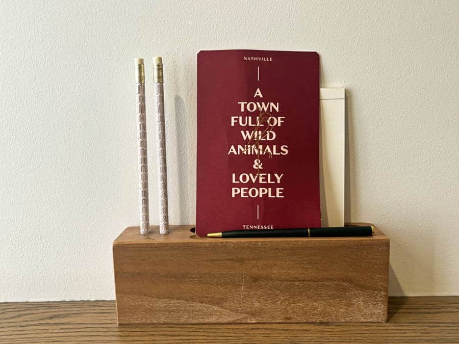 A pen holder with a small card with a Nashville quote