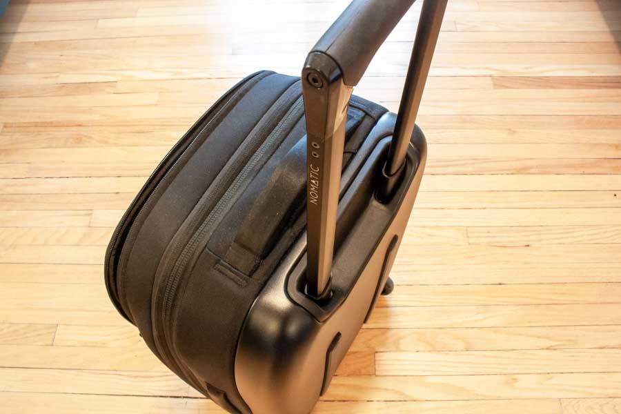 The aluminum handle of Nomatic Navigator Carry On