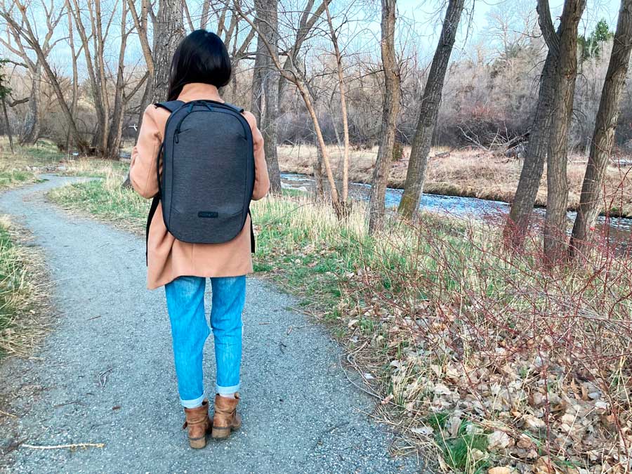The author wearing the Nomatic Navigator Lite Backpack during a walk