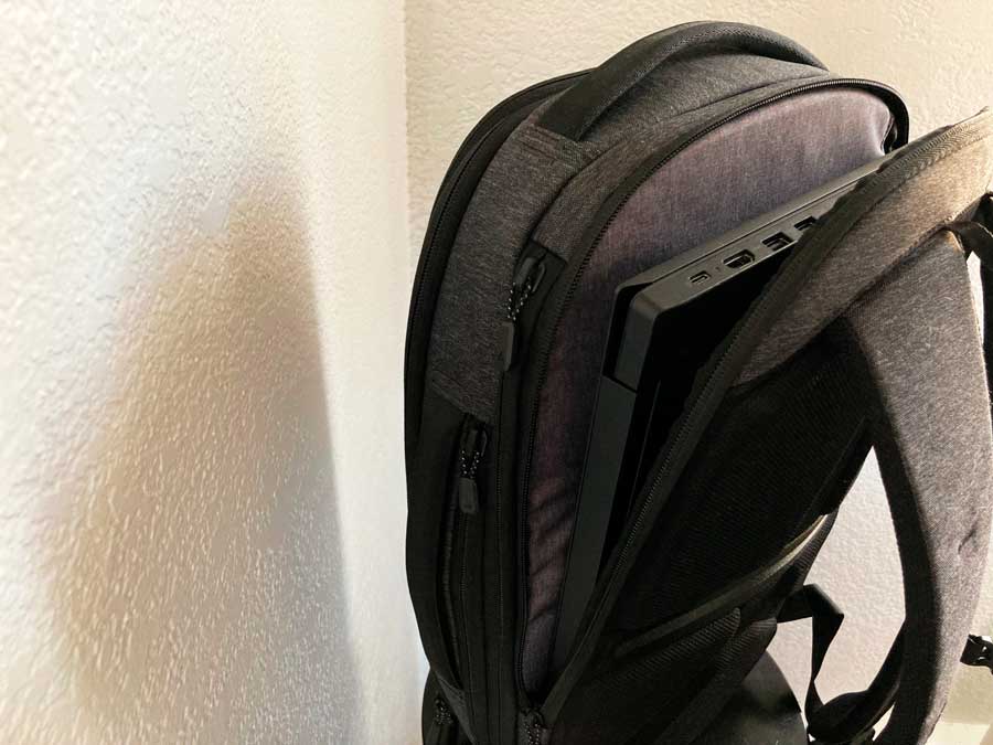 A laptop on the laptop pocket of Nomatic Navigator Lite Backpack