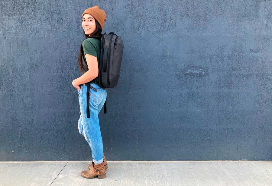 The author wearing her Nomatic Navigator Backpack