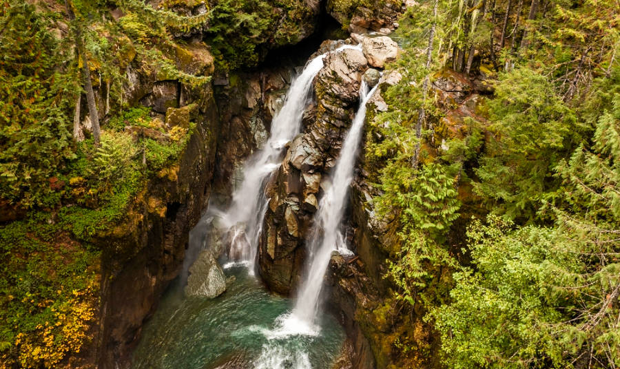 Aerial view of the scenic twin fall of Nooksack Falls in the middle of a forest