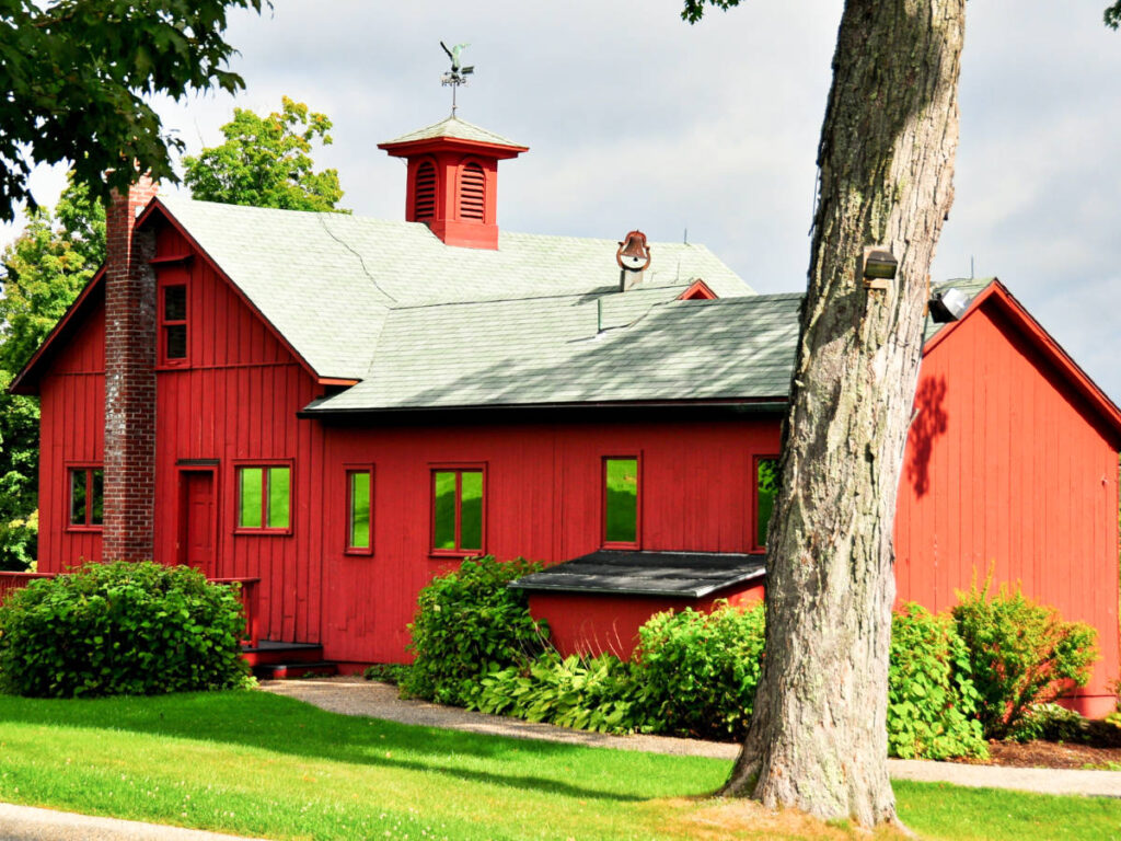 View of the vibrant red exterior of Norman Rockwell Studio in Stockbridge