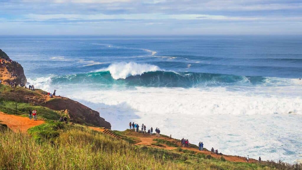 View of people admiring the view in North Beach of Nazaré