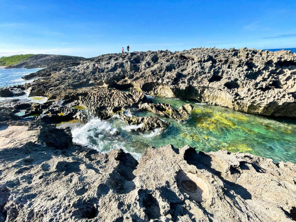 People walking at the rock formations of North Coast Beach