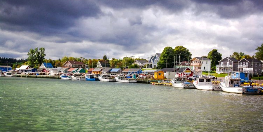 View of boats and colorful houses in North Rustico