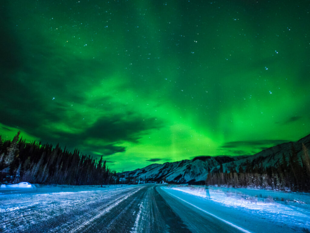 Aurora borealis illuminating the road in Fort Nelson