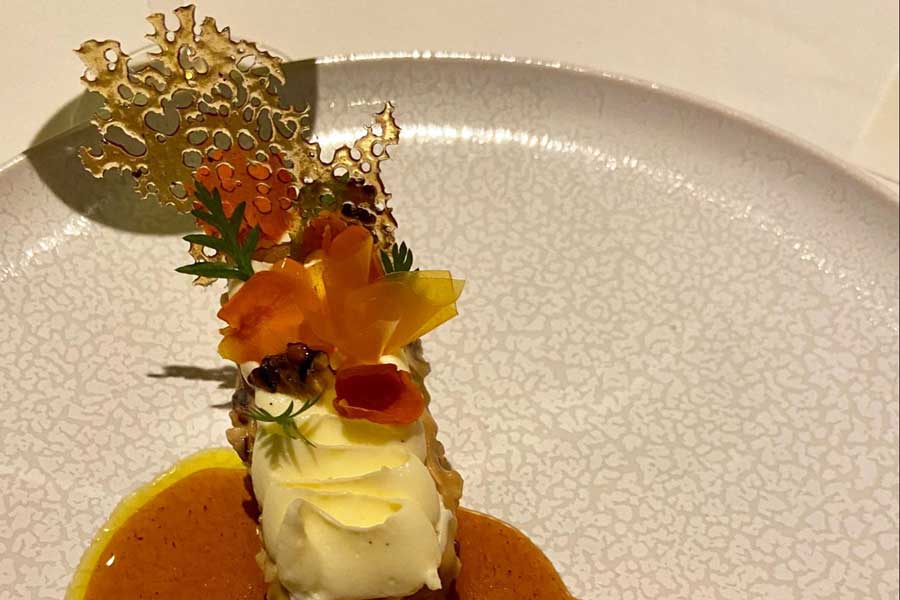 A fancy carrot cake on a plate in Number One