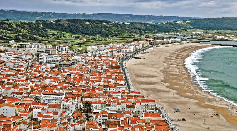 Aerial view of the beach, mountains, and the town of Nazare