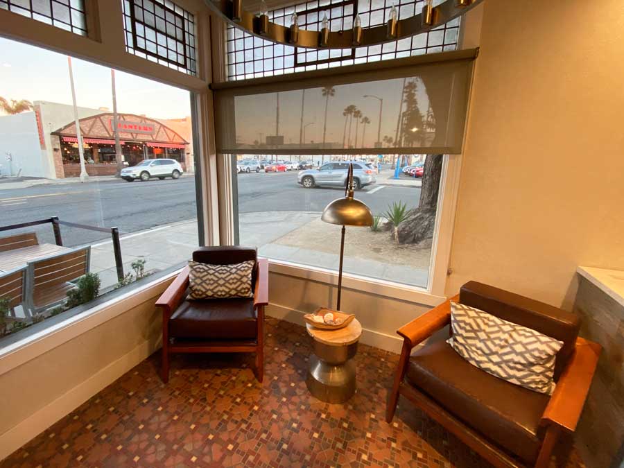 View of a street in Oceanside from the inside of The Fin Hotel