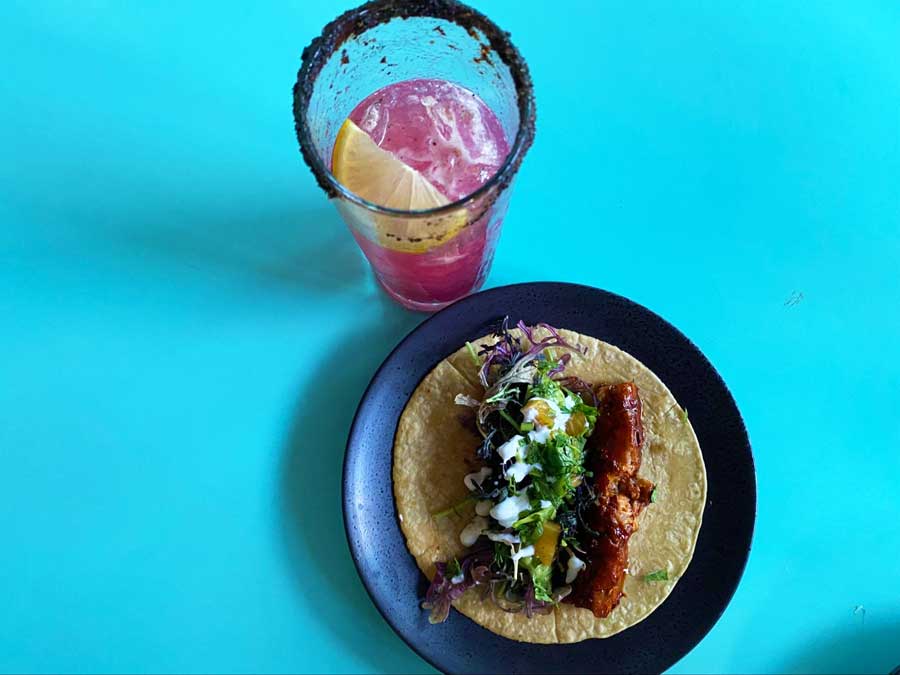 A plate of food and a glass of drink on a table in Oceanside