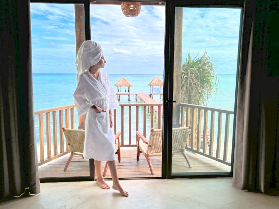 Clara in front of the private balcony at the beachfront room of Nerea boutique hotel Tulum