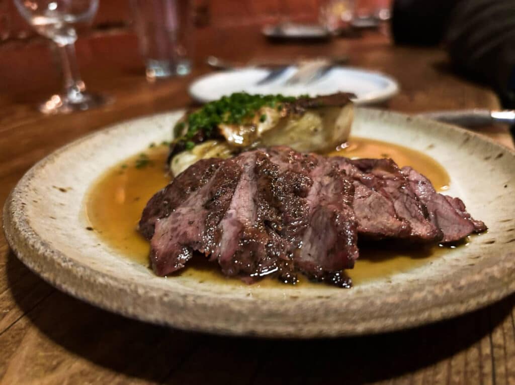 A plate of sliced meat dish from Off Alley