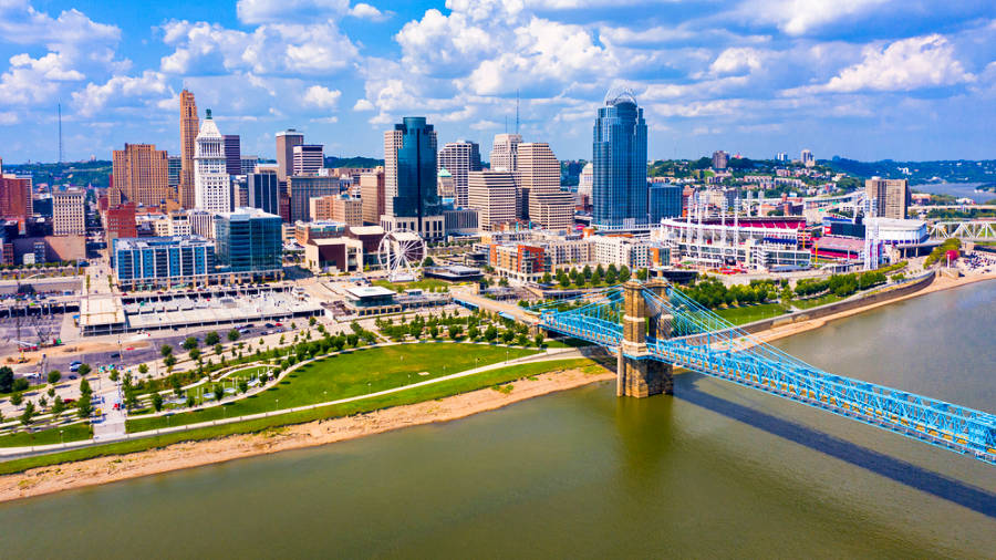 Aerial view of the John A. Roebling Bridge, Ohio skyline and river on a sunny day