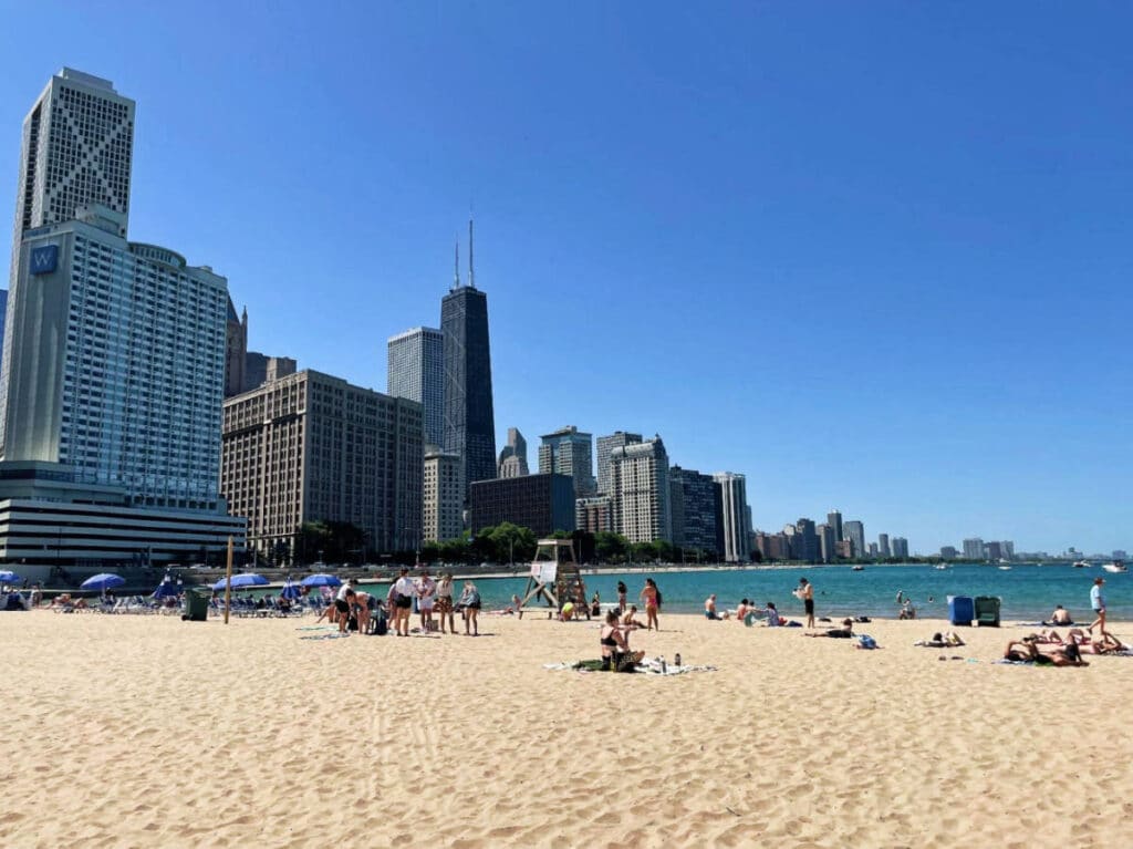 People enjoying their day under the clear blue sky in Ohio Street Beach