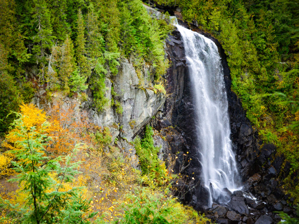 A picturesque Ok Slip Falls amidst lush green trees and foliage