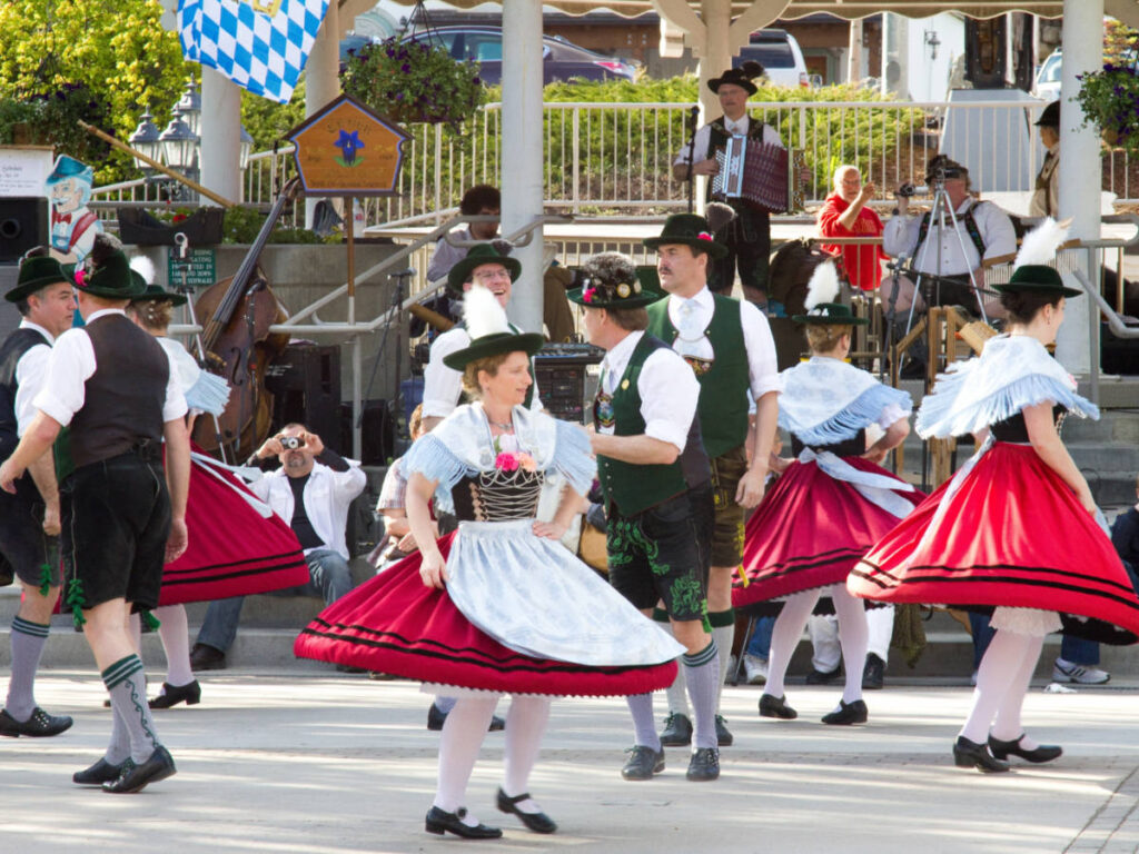 People wearing a traditional attire and dancing during a festival in Leavenworth