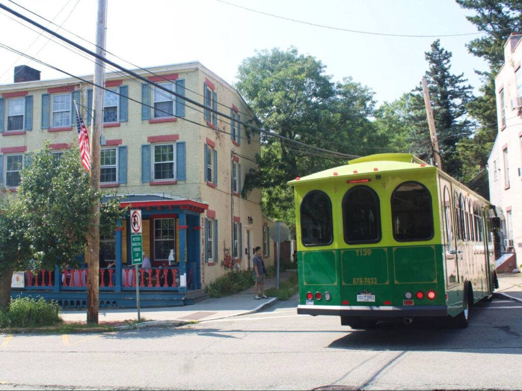 An old bus driving around the town of Beacon