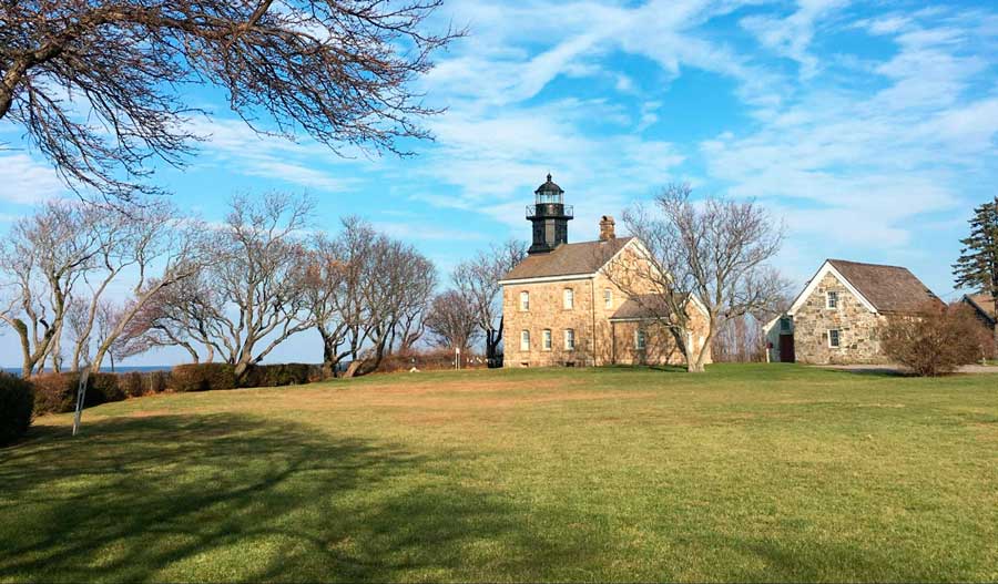 View of the Old Field Point Lighthouse in a green field