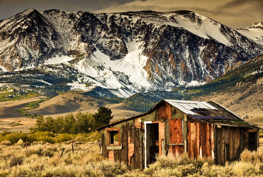 View of an old building with a scenic view of the snowy mountain in Old Mammoth