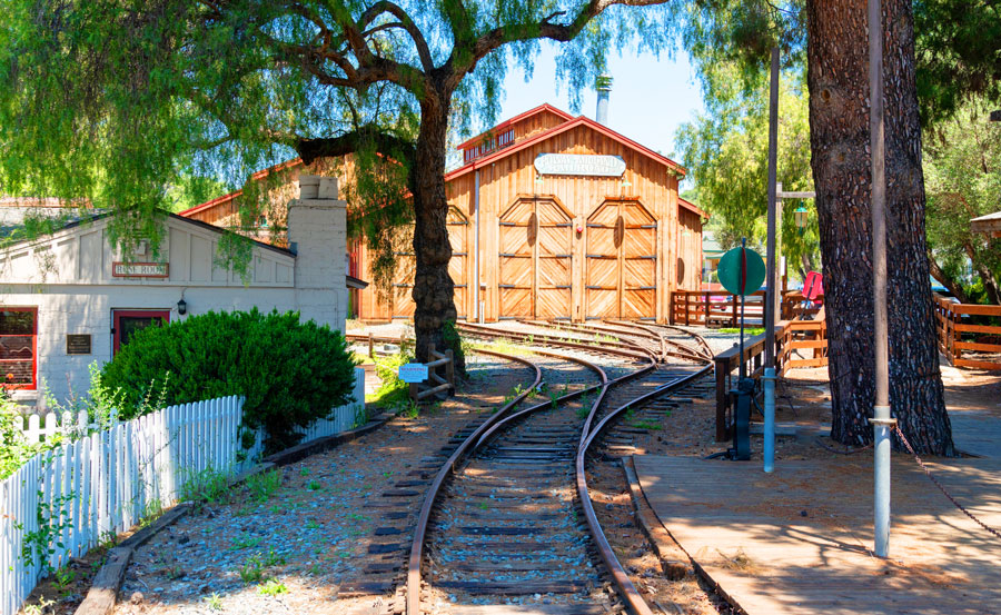 View of Old Poway park village and a railroad