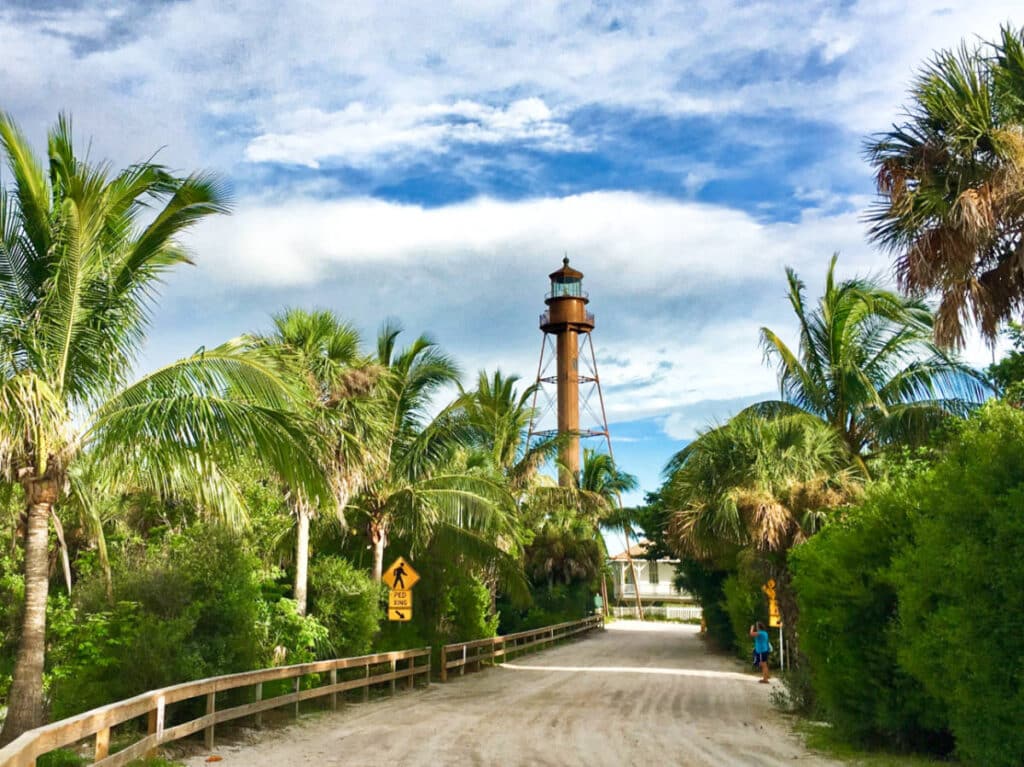 View of the Old Sanibel Island Lighthouse surrounded by greenery from a distance