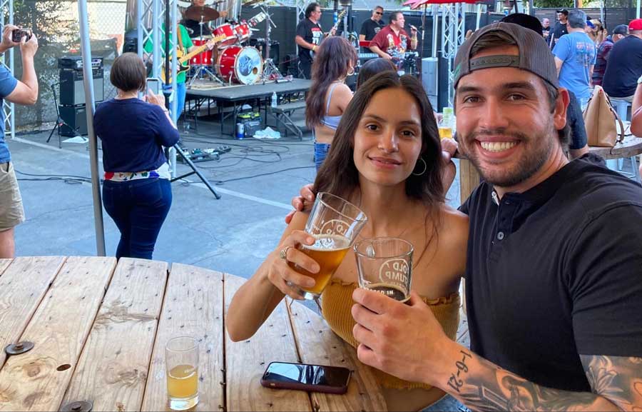 The author with her cousin holding a glass of beer from Old Stump Brewing Company