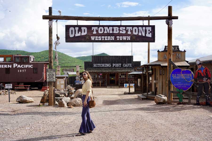 The author's friend posing for a photo in front of the Old Tombstone signage