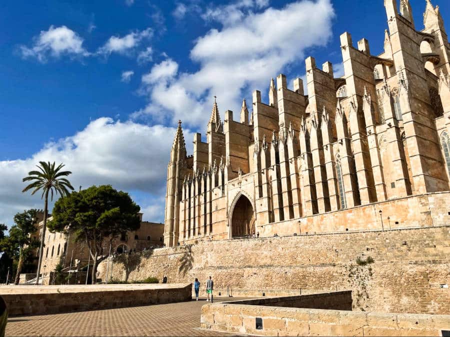 People strolling at the façade of the magnificent Palma Cathedral at Parc de la Mar
