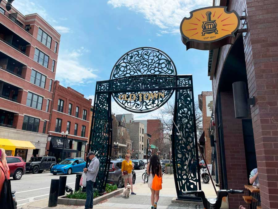 People going under the Old Town sign on N Wells Street