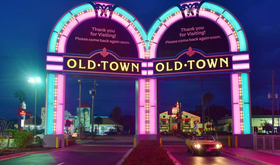 View of a vintage car passing through the illuminated Old Town
