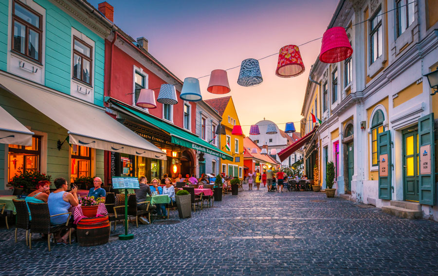 View of a colorful street with restaurants and coffee shops