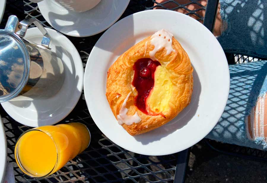 A pastry with cherry and custard on a plate in Olsen’s Danish Village Bakery