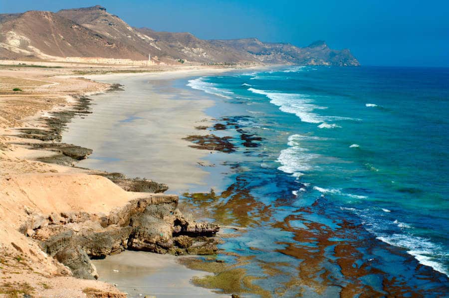 View of the turquoise blue water and the rocky shoreline