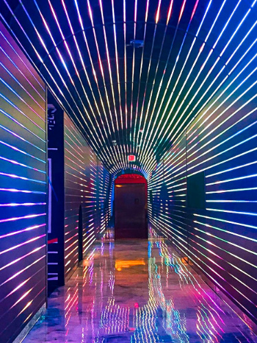 A pathway with colorful lights at Omega Mart