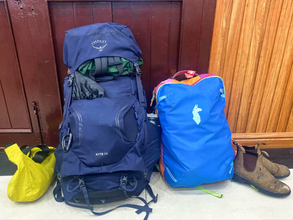 Two backpacks, a day bag and a pair of boots