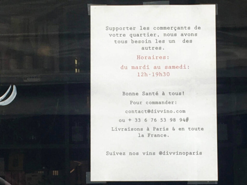 View of a paper displaying the Opening Hours of a wine shop