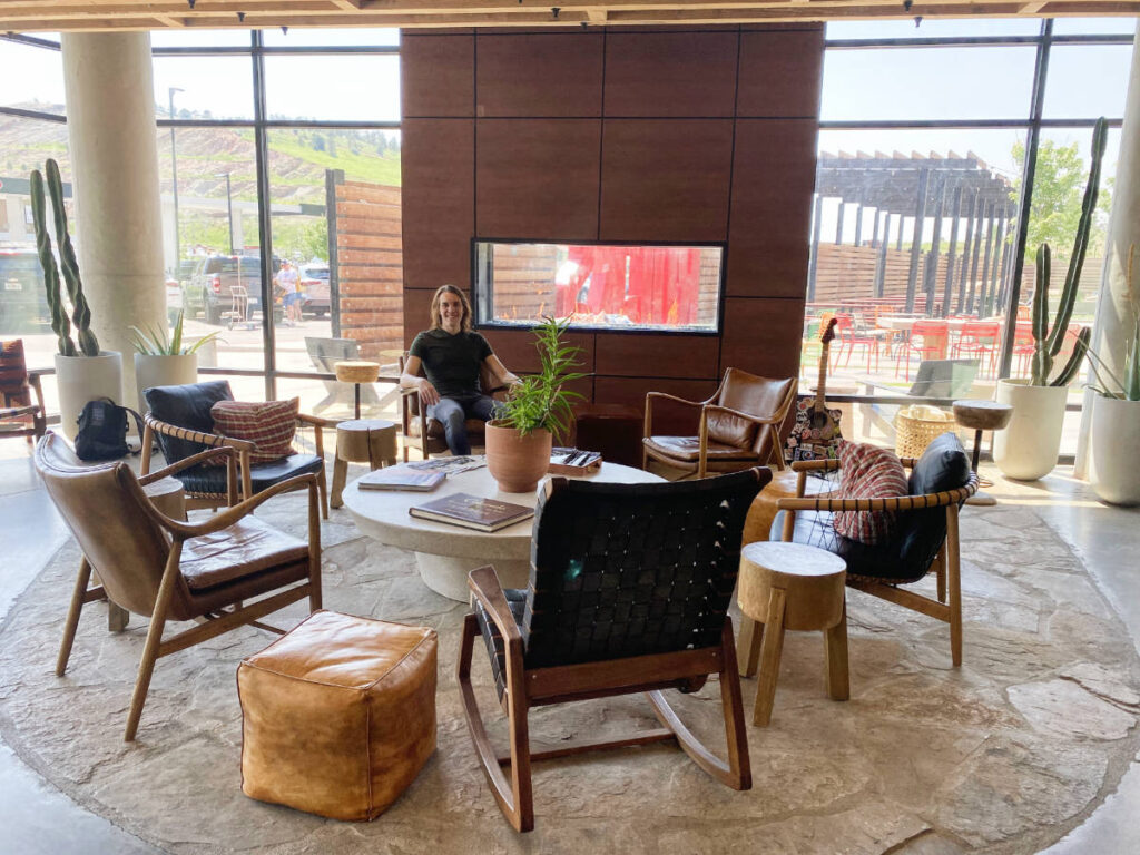 The author, Nate Hake sitting at the lobby of Origin Hotel Red Rocks