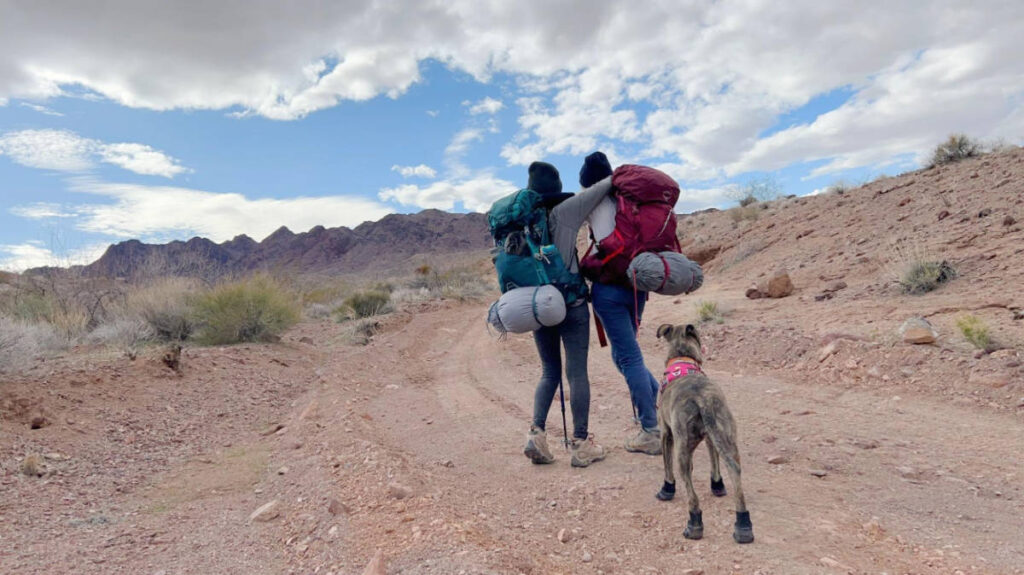 The author with her friend, and a dog during a hike