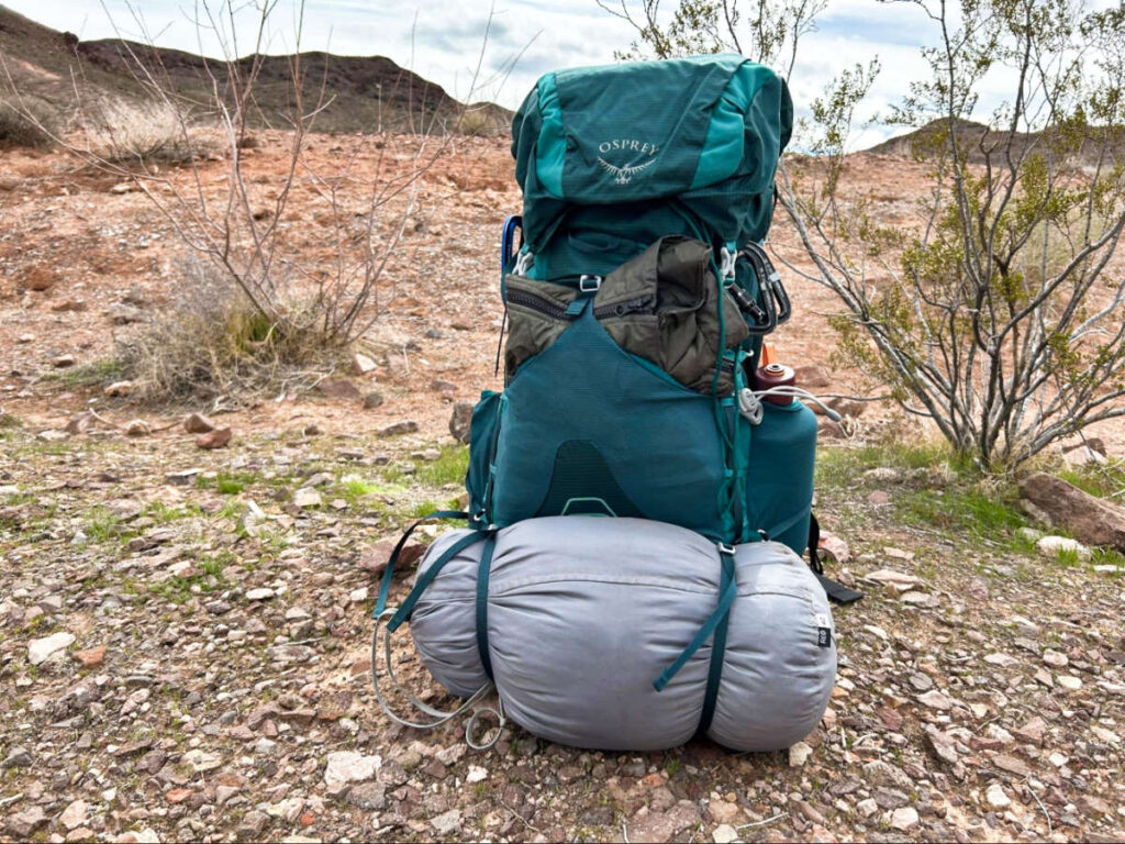 The Osprey Eja Backpack standing freely on the land