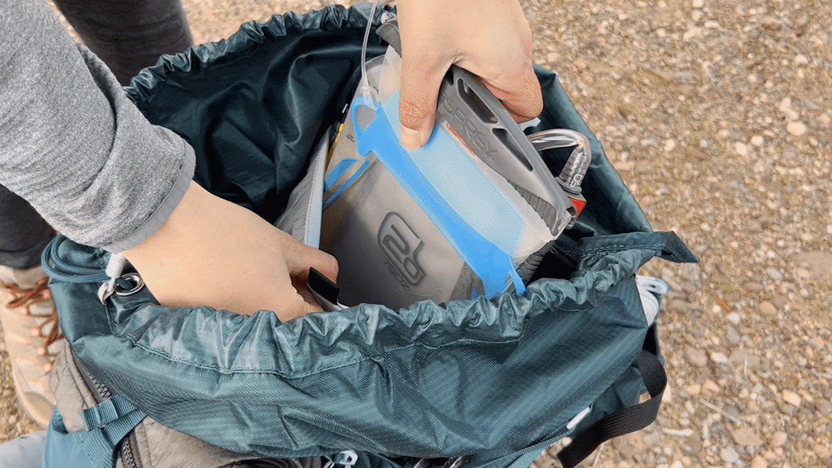 A demonstration of putting the hydration sleeve into the sole pocket in the main compartment of the Osprey Eja Backpack