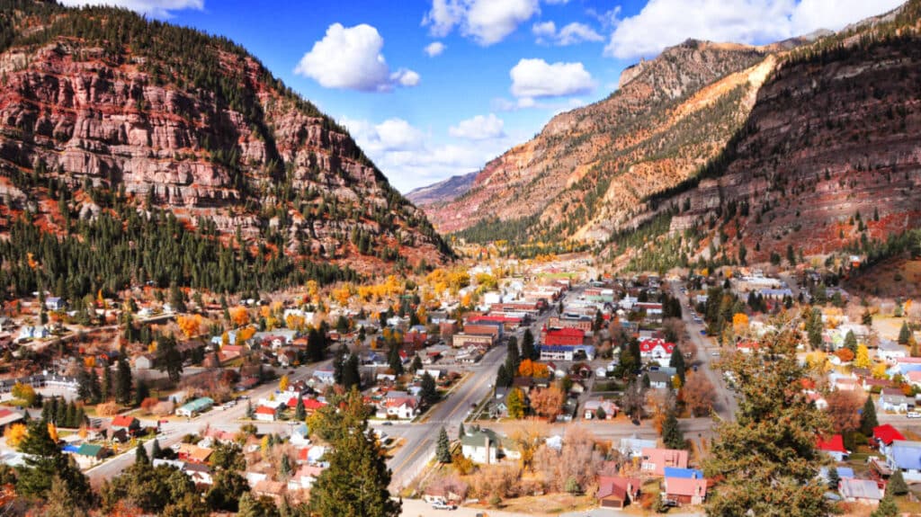 Aerial view of Ouray Town and the rocky mountains around it in Autumn