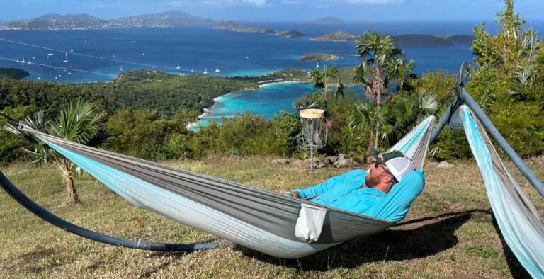 Author Andrew relaxing on a hammock with the overlooking St. Thomas from a mountain top on St. John