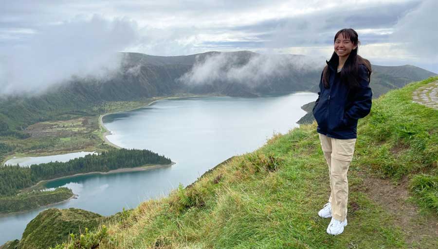The author smiling for a photo with a view on her background